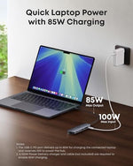 Anker multiport docking station plugged into a premium laptop demonstrating workspace cable setup.