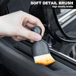 Black synthetic ultra soft detailing brush sweeping dust off a delicate leather car seat