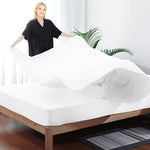Oversized white King size flat sheet showing ample fabric length for tight tucking