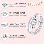 Adjustable sterling silver fidget ring with moveable ball beads for stress relief on a model's thumb.