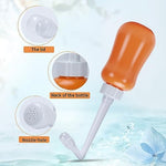 Upside down ergonomic design of FOOFOO orange peri bottle.