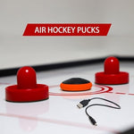 TYRDAN air hockey puck gliding effortlessly on a smooth household floor surface.