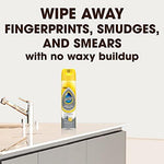 Pledge Expert Care aerosol can being applied to a modern stainless steel microwave