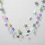 Three individual strands of holographic star streamers hanging from a ceiling setup