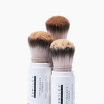 DRMTLGY mineral powder brush showing the medium tan tint for sun protection