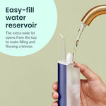 Full kit view of the Quip water flosser including the extra replacement tip and charger.