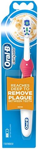 Oral-B power electric toothbrush head demonstrating the replaceable brush head mechanism.