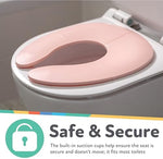 Underneath view of pink Nuby travel potty seat highlighting built-in suction cups