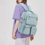 Lohol blue backpack showing multiple front zipper pockets and elastic bungee cord system