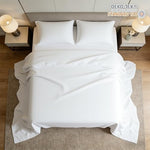 Close up view of the elegant four inch hem piping details on the white microfiber bedding.