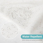 Detailed shot of the reinforced metal grommets and included white plastic hooks on the linen curtain.