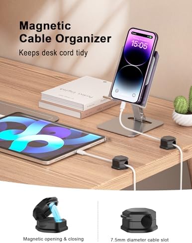 Close up of a black magnetic cable clip being opened with one hand to insert a USB cable.