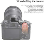 Ergonomic camera thumb rest mounted on a mirrorless camera hot shoe illustrating single-handed grip comfort.