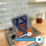 Astonish oven cleaner being applied to a greasy oven rack using the dual sided scrubbing sponge