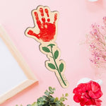 Finished colorful handprint art bouquet displayed elegantly inside a ceramic room decor vase for grandmothers