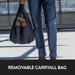 Side angle view of the black Evenflo travel bag showing the supported bottom panel designed to hold up to 7 pounds.