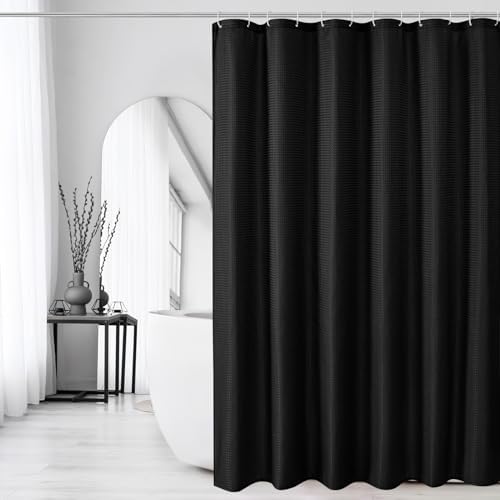 Gibelle seventy two inch square black textured curtain draped elegantly next to a white bathtub.