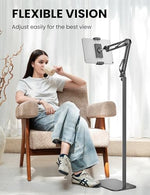 SteelStorm metal floor stand placed next to a bed demonstrating ergonomic height adjustment for reading.