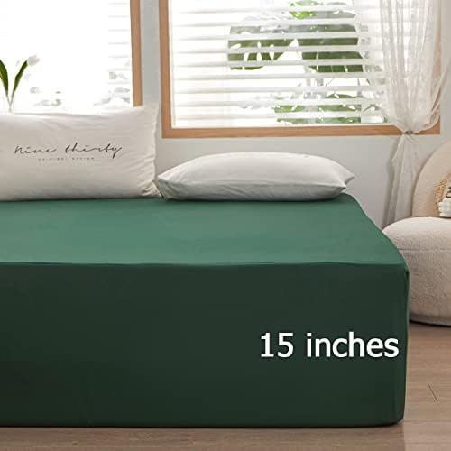 Dark green twin sheet neatly fitted on a mattress