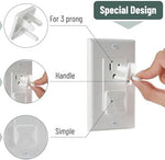 White child safety outlet covers installed on wall