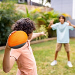 A lifestyle view showcasing the soft foam build of the junior football ideal for family playtime