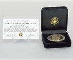 Twenty-four karat gold plated American Eagle Liberty tribute coin on desktop stand