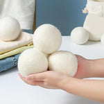 Extra large white wool laundry balls for eco-friendly fabric softening.
