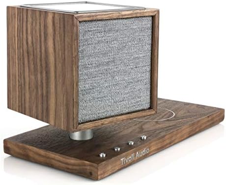 Tivoli Audio Revive premium Walnut finish speaker styled elegantly on a modern bedroom nightstand setup.