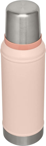 Stanley 18/8 stainless steel thermos flask with collapsible handle extended for carrying.