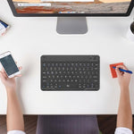 Rii wireless smart television keyboard placed on a living room table showing its remote media control functionality
