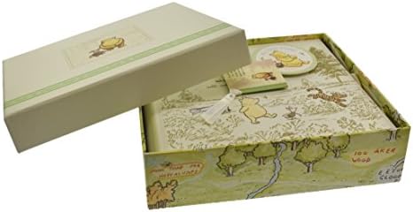 Close up of cream cover illustration featuring Pooh and Piglet on the baby keepsake book.