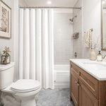 Close up view of the boho farmhouse neutral cream linen blend bathroom curtain fabric material.