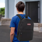 Trail Maker unisex black travel and school bag being held by the top handle.