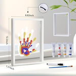 White wooden keepsake picture frame displaying overlapping multi generational handprints of parents child and pet paw.