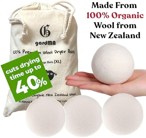 Four extra large reusable wool dryer balls arranged together on a laundry surface
