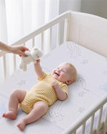 Folded view of the portable mini crib mattress showcasing its compact trifold design and lightweight structure