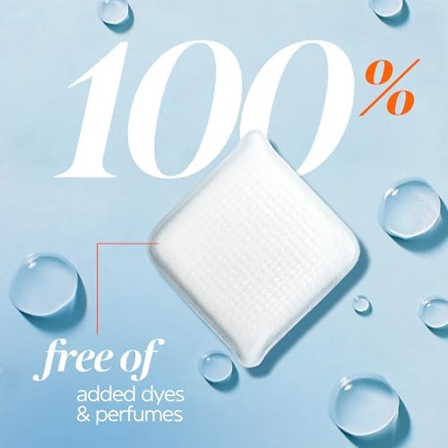 Hypoallergenic fragrance free laundry tile being placed into an empty washing machine drum