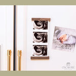 Oscar Bee magnetic ultrasound keepsake frame mounted vertically on a clean refrigerator door