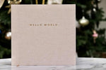 Minimalist gender neutral milestone photo album showing premium linen fabric texture