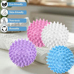 Multi colored thermoplastic rubber laundry balls separating clothes inside a dryer drum to reduce wrinkles