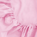 Pink fitted sheet showing deep pocket fit on mattress