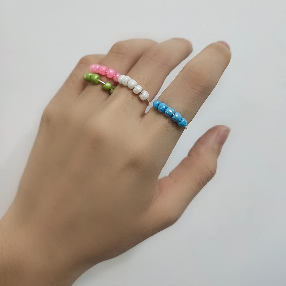 Full collection of eight OIDIMS colorful bead stacking rings laid out together.