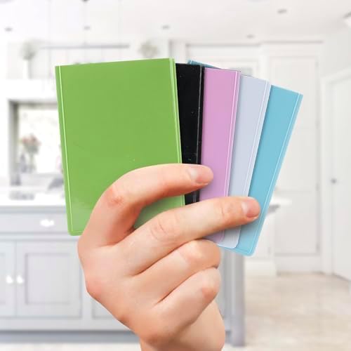 Vibrant credit card sized instant photo prints displayed inside colorful mini magnetic refrigerator frames.