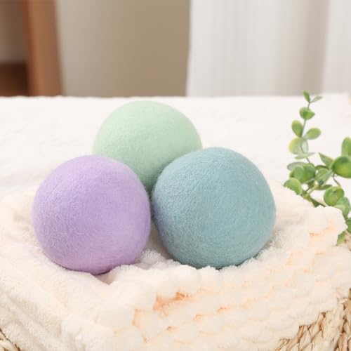 Extra large New Zealand wool laundry balls tumbling inside a machine dryer