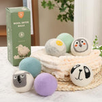 Chemical free hypoallergenic wool balls placed next to freshly dried towels