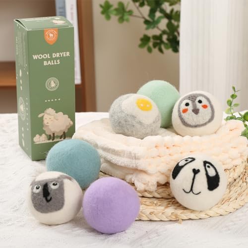 Chemical free hypoallergenic wool balls placed next to freshly dried towels