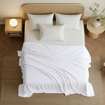 White queen size flat sheet folded neatly on a bed