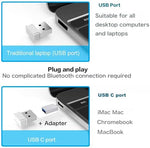 Premium silver dual-mode Bluetooth mouse placed next to an open MacBook laptop and tablet computer.