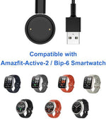 Lettou smartwatch charging cord extended to its full 3.3 feet length alongside a standard USB power connector