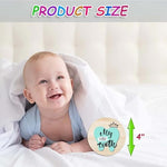 Newborn baby photographed with Roranic holiday milestone wooden prop